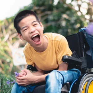 Boy in wheelchair shouting and excited